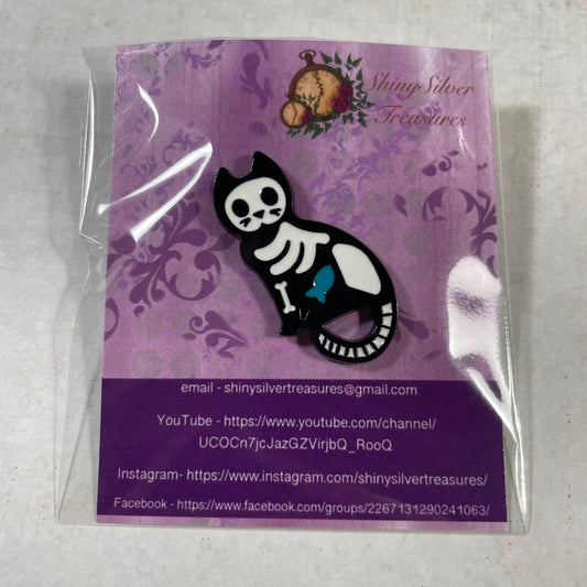 Skeleton cat sitting with fish enamel pin badge with rubber back